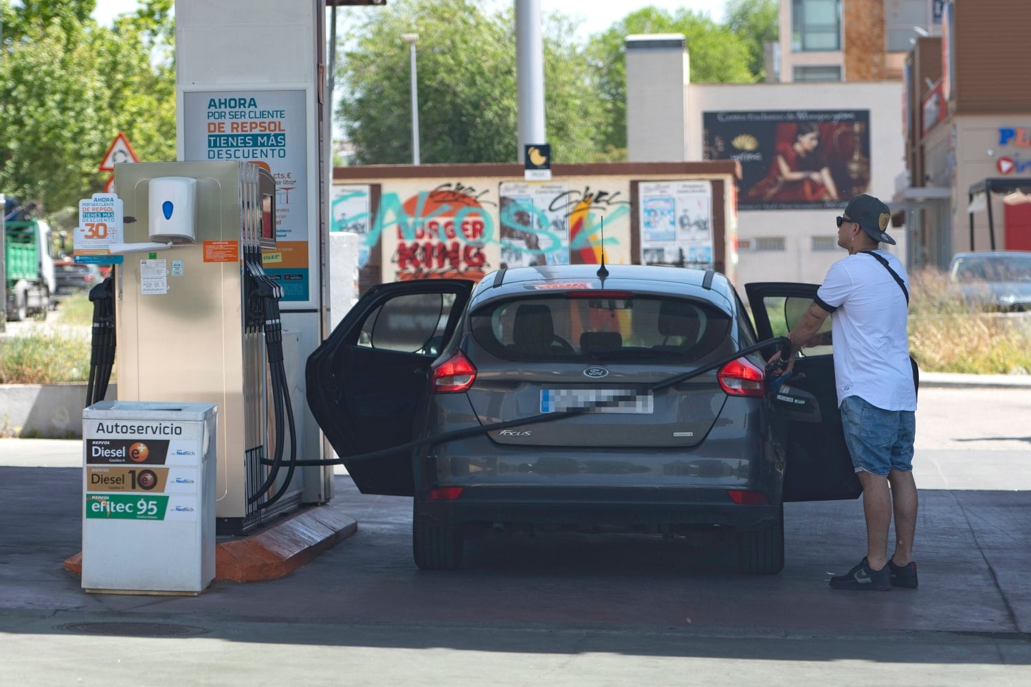 Un consumidor llena el depósito de su coche en una de las gasolineras más baratas / EP