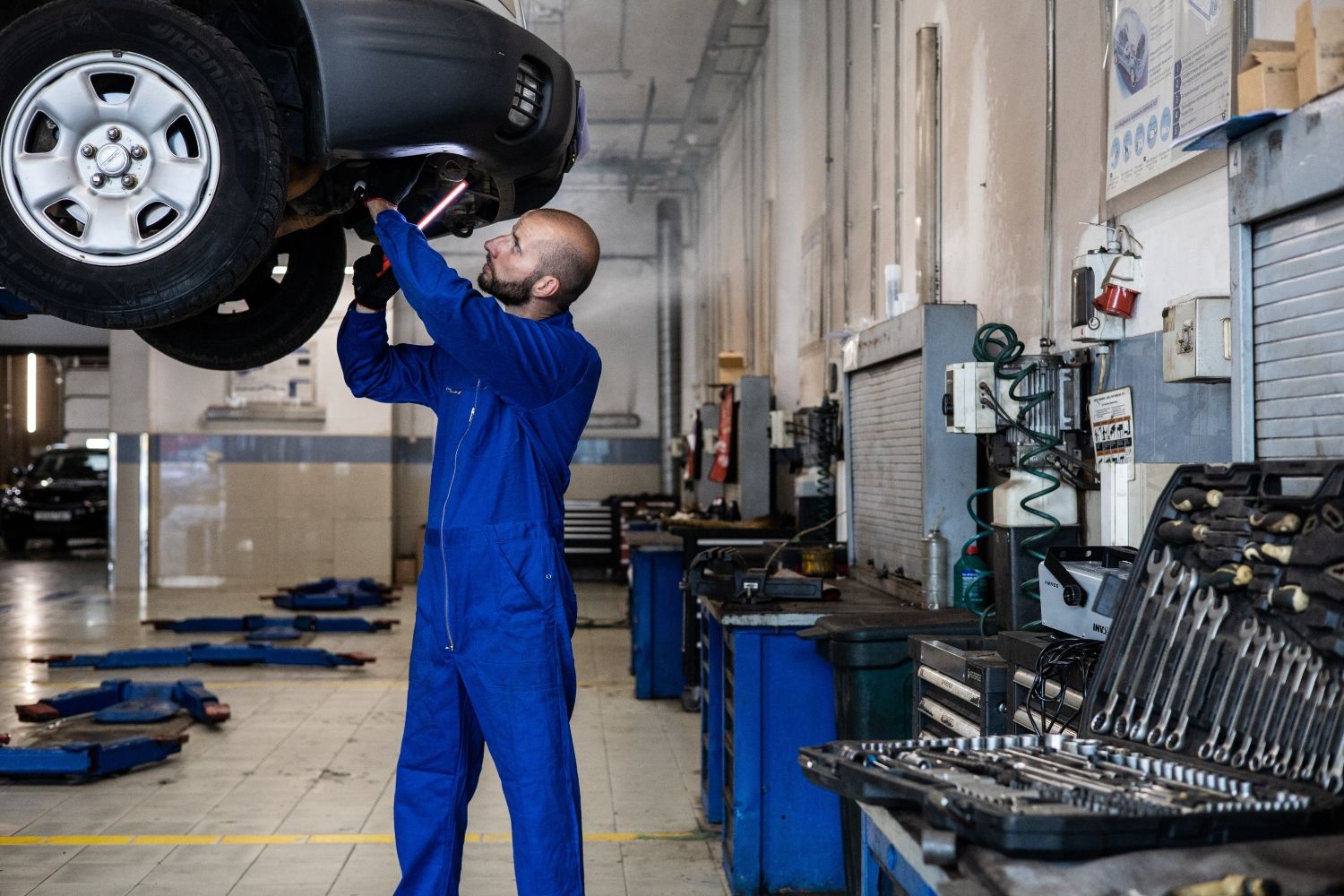 Un mecánico repara un coche en un taller / PEXELS