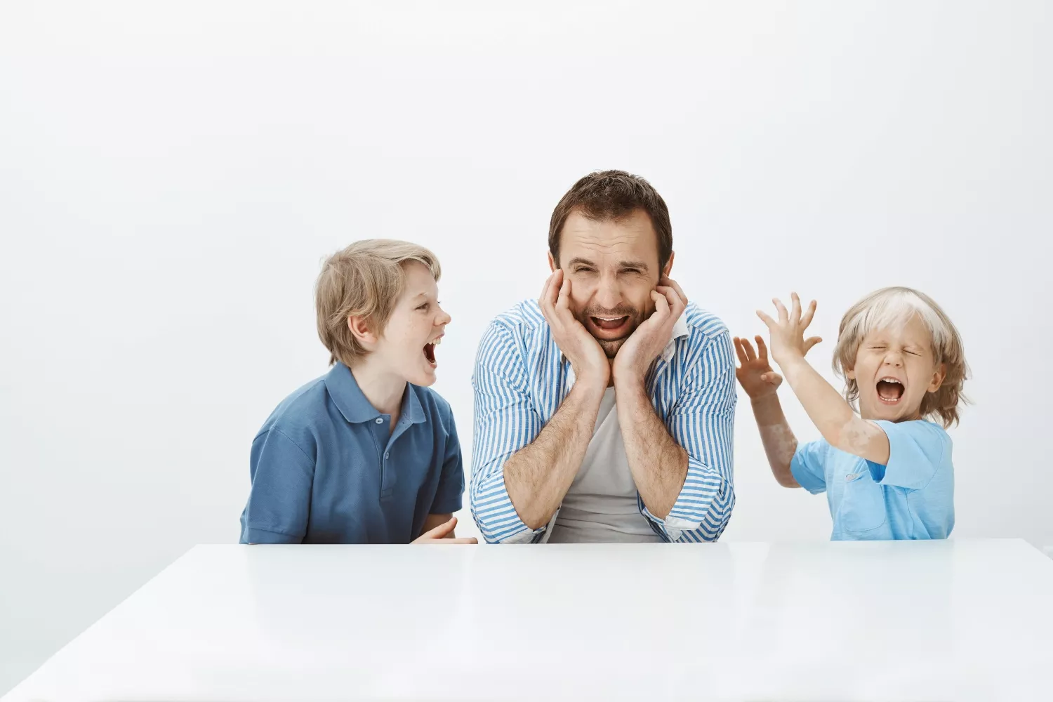 Niños gritando delante de su padre / FREEPIK