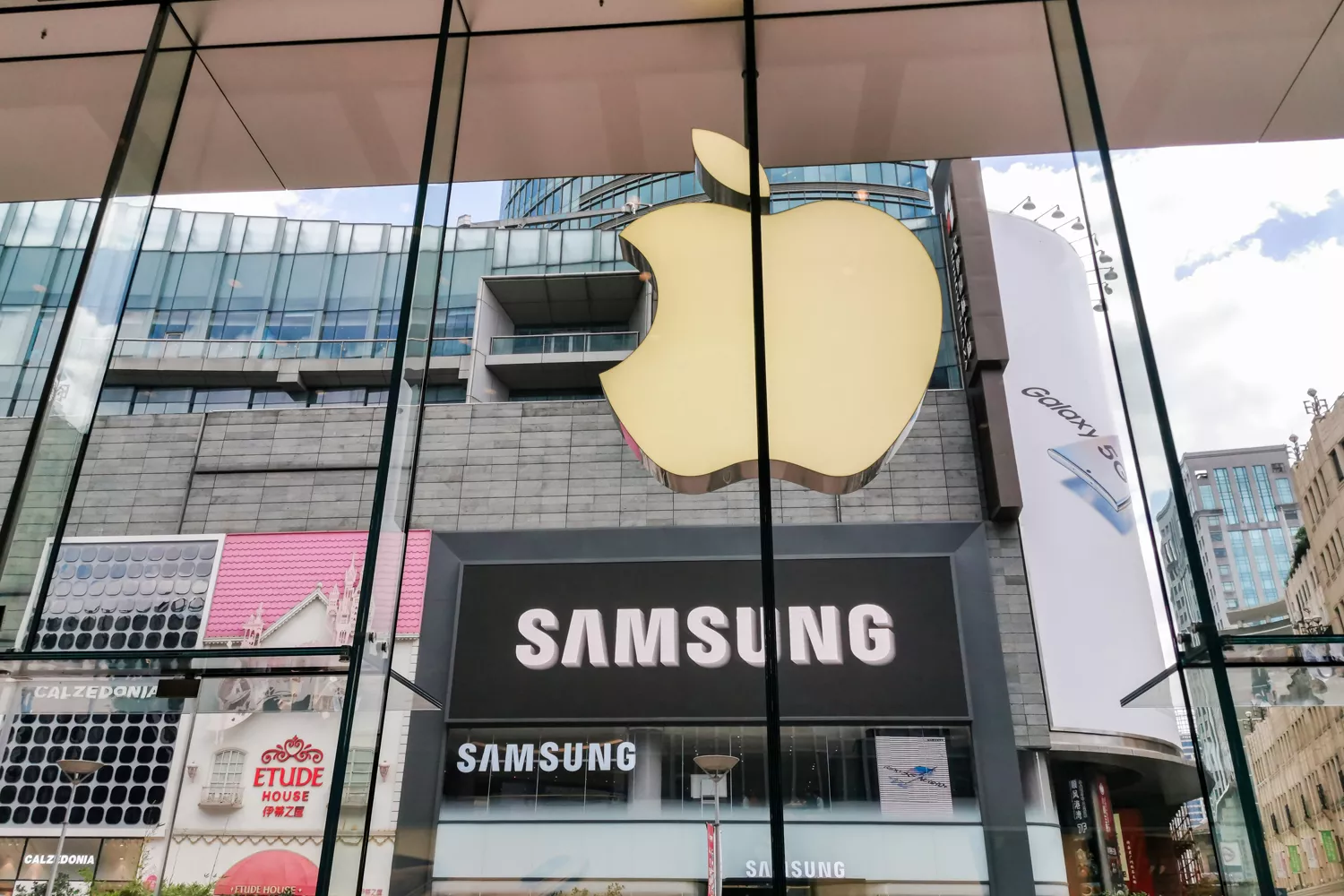 El logo de Apple en una tienda frente a otra de Samsung / ZUMA - DPA