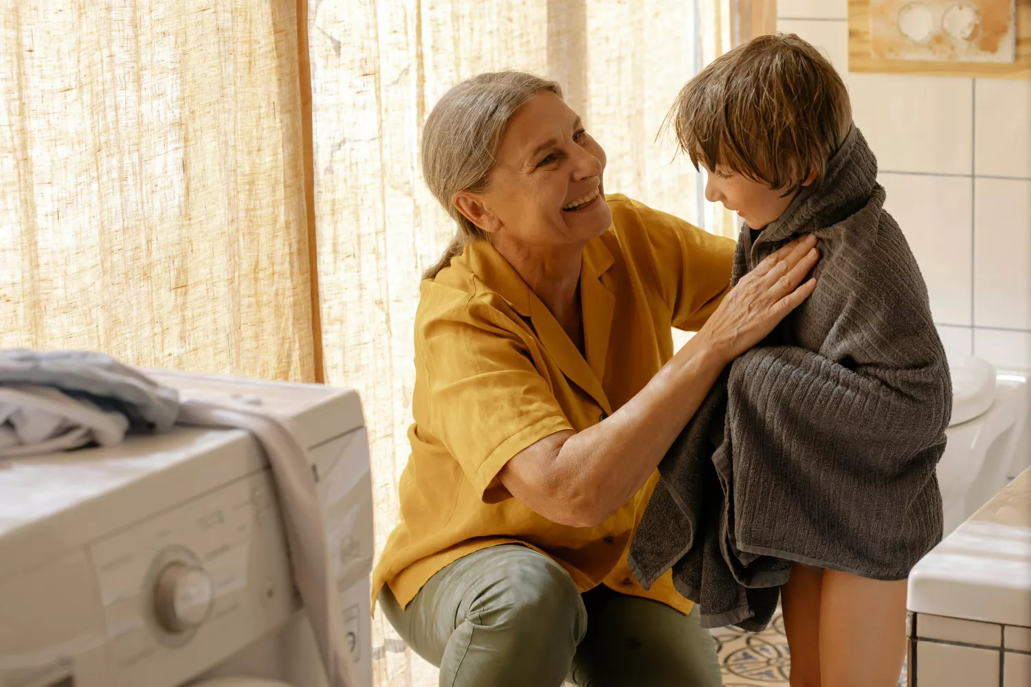 Una abuela seca a su nieto con una de las toallas suaves que tiene / PEXELS